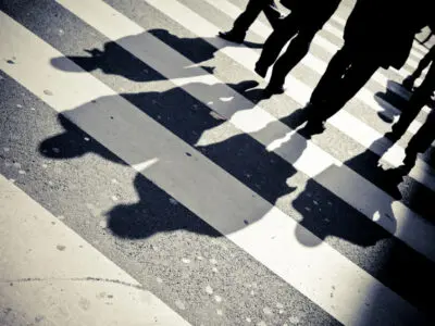 several pedestrians walking in a crosswalk