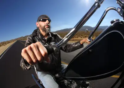 biker with beard driving down the highway