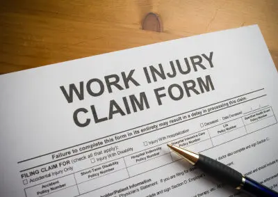 work injury claim form with pen