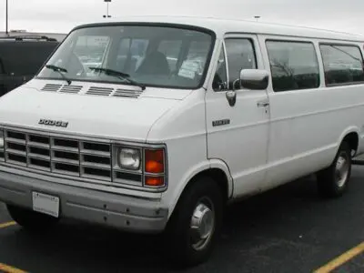 white 15-passenger van in parking lot