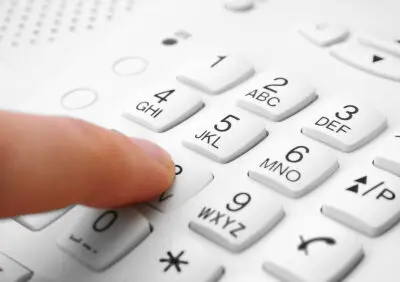person using a push button telephone