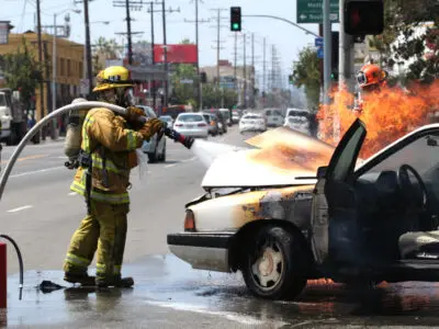 fireman extinguishing a car fire