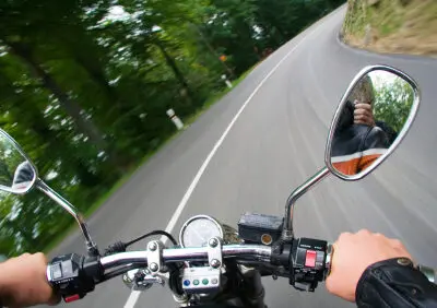 biker driving down two-lane road