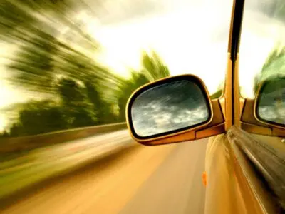 sideview mirror on a speeding car