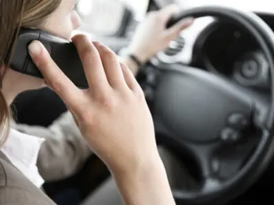 woman talking on cellphone while driving