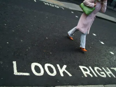 woman with pink coat in crosswalk