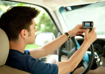 young man texting while driving