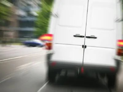 white passenger van speeding on the street