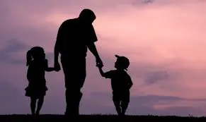 a father holding hands with two children