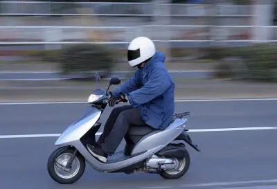 person riding a vespa