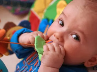 baby chewing on teething toys