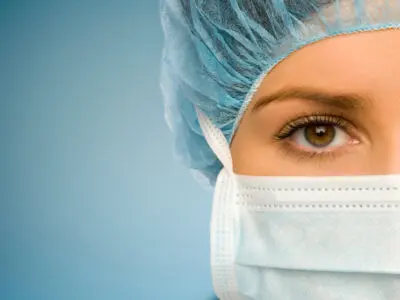 close-up of doctor with mask and head covering
