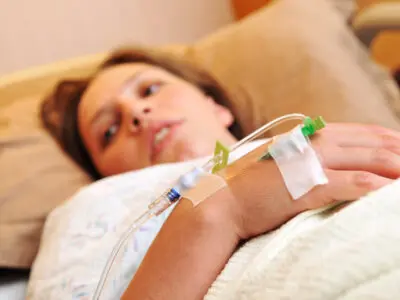 pregnant patient with IV in hand