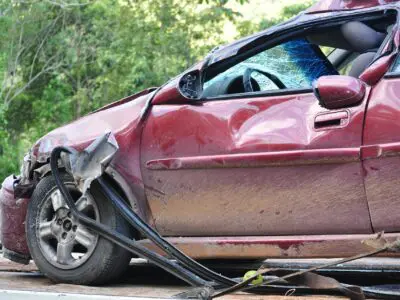 red car badly damaged on driver's side