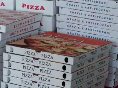 four large stacks of pizza delivery boxes