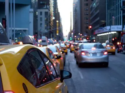 busy city street with taxis and passenger cars