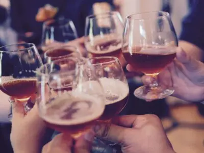group of people clinking their wine glasses together
