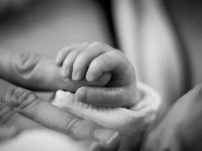 black & white photo of a baby's hand
