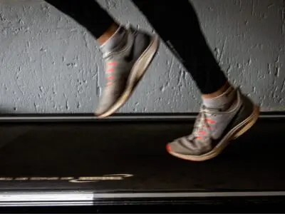 Closeup runner's feet on treadmill