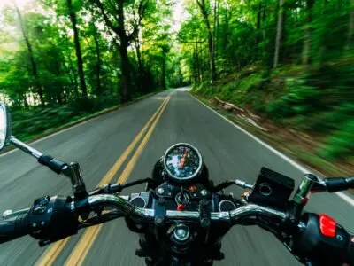 A motorcycle on the road from the driver's point of view.