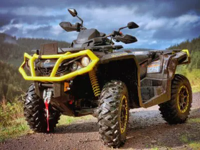 An ATV with mountain-like terrain in the background.