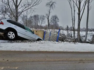 Damaged SUV in a ditch to the side of the road.