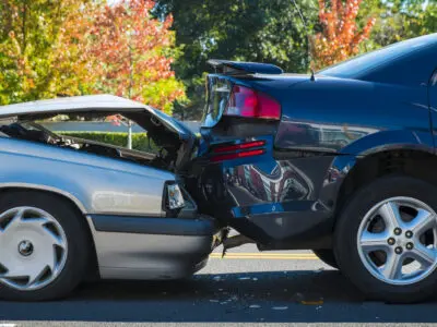 A rear-end collision involving two cars.