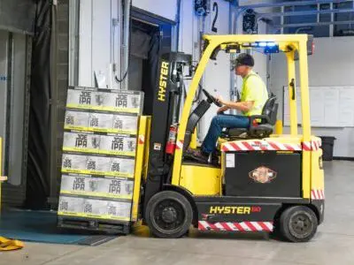 yellow forklift picking up packages