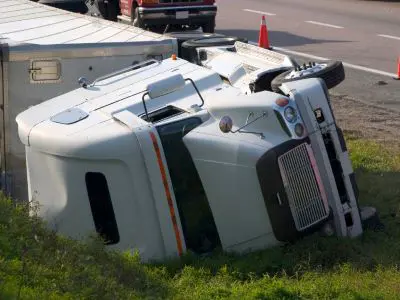 A big rig turned on its right side following a highway accident.