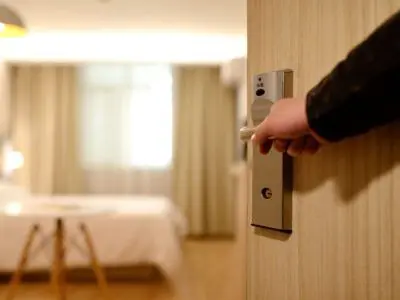 hand opening a hotel door