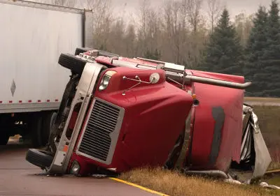 red crashed semi laying on its side