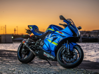 A blue motorcycle in the sunset.