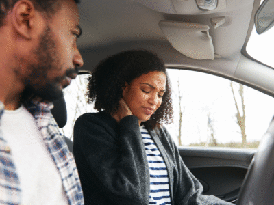 Two friends, one driving and one in the passenger seat.