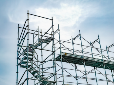 Construction scaffolding with elevated platforms and access stairs highlights how OSHA scaffolding regulation violations, including lack of fall protection and unstable structures, can lead to serious construction site accidents and liability claims in Atlanta.