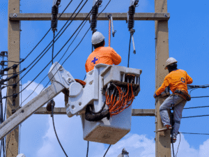 Utility workers repairing power lines on electric poles